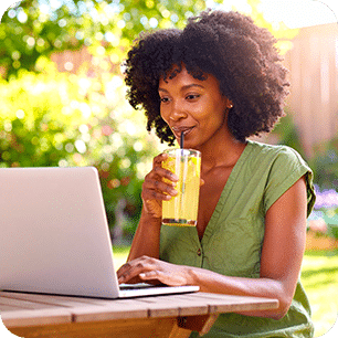 Woman enjoying lemonade while working